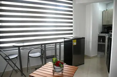 a kitchen with a table and two chairs and a table and a table sidx sidx at Divino Apartamento Moderno con la Mejor Ubicación in Manizales