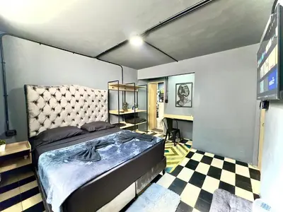 a bedroom with a large bed and a checkered floor at Spacious dream house Medellín Laureles in Medellín