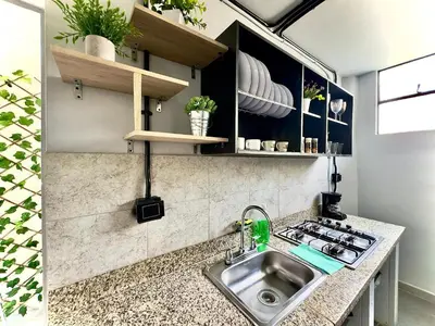 a kitchen with a sink and a stove at Spacious dream house Medellín Laureles in Medellín