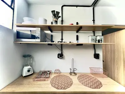 a kitchen with wooden counter tops and shelves at Spacious dream house Medellín Laureles in Medellín