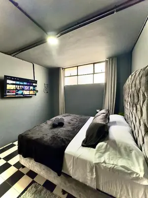 a bedroom with a large bed in a room at Spacious dream house Medellín Laureles in Medellín