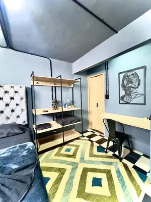 a bedroom with a bed and a desk and a keyboard at Spacious dream house Medellín Laureles in Medellín