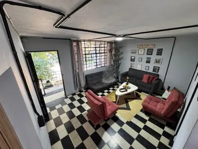 a living room with a couch and a table at Spacious dream house Medellín Laureles in Medellín