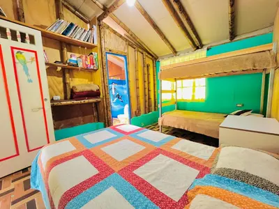 a bedroom with a bed with a colorful quilt at Hospedate entre Cascadas, Senderos y Paisajes Naturales in Jardin