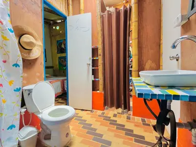 a bathroom with a toilet and a sink at Hospedate entre Cascadas, Senderos y Paisajes Naturales in Jardin