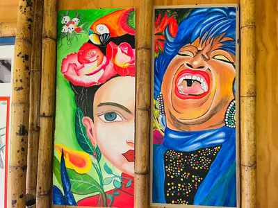 two paintings of a woman on a wall at Hospedate entre Cascadas, Senderos y Paisajes Naturales in Jardin