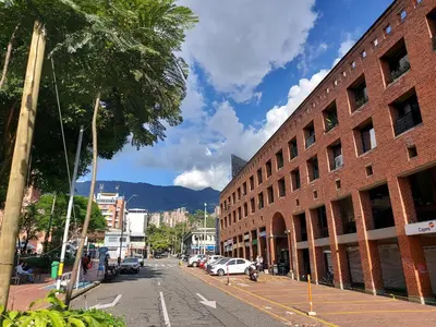 an empty city street with a red brick building at Loft en el exclusivo barrio Poblado - Medellín in Medellín