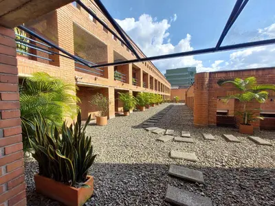 a courtyard with potted plants in front of a building at Loft en el exclusivo barrio Poblado - Medellín in Medellín