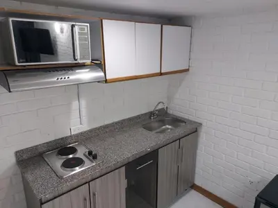 a small kitchen with a sink and a microwave at Loft en el exclusivo barrio Poblado - Medellín in Medellín