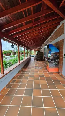 an outdoor patio with a wooden ceiling and a tile floor at Casa campestre, Guarne-Aeropuerto José María Córdova in Guarne