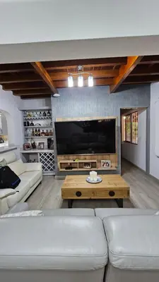 a living room with a large flat screen tv at Casa campestre, Guarne-Aeropuerto José María Córdova in Guarne