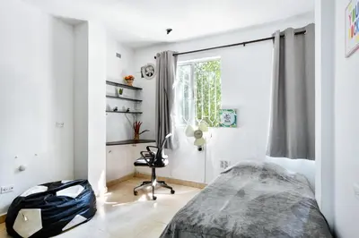 a bedroom with a bed and a window at International House Co-Living in Medellín