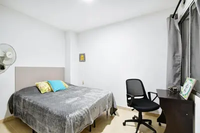 a bedroom with a bed and a desk and a chair at International House Co-Living in Medellín