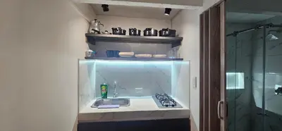 a small kitchen with a sink and a stove at Hermosa casa con espacios independientes cerca a Mall plaza in Manizales