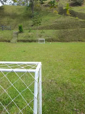 a soccer goal in a field of grass at Acogedora Casa De Campo Con Jakuzzi, Descanso Garantizado in El Peñol