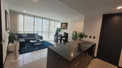 a kitchen and living room with a sink and a couch at Amazing apartment in el Poblado in Medellín