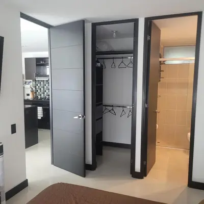a room with two sliding doors and a kitchen at Amazing apartment in el Poblado in Medellín