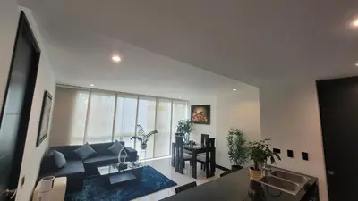a living room with a blue couch and a sink at Amazing apartment in el Poblado in Medellín