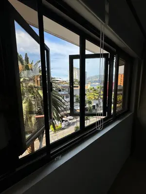 a window with a view of a city at Casa RAPA La70 in Medellín