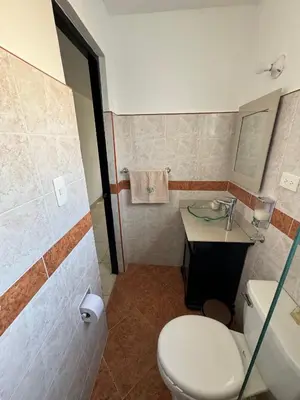 a bathroom with a toilet and a sink at Casa RAPA La70 in Medellín