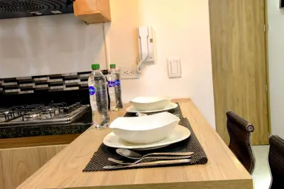 a table with two white bowls and plates on it at ALOJARTE RIONEGRO - Acogedor estudio - ubicación privilegiada in Rionegro
