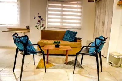 a living room with a couch and two chairs and a table at ALOJARTE RIONEGRO - Acogedor estudio - ubicación privilegiada in Rionegro