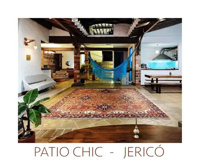 a living room with a rug and a hammock in a room at Patio Chic House in Jericó