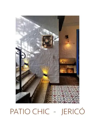 a staircase in a room with a stone wall at Patio Chic House in Jericó