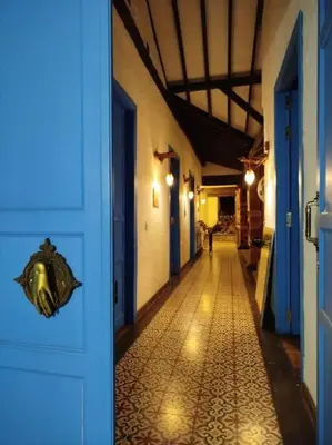 a hallway of a building with a blue door at Patio Chic House in Jericó
