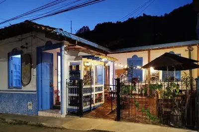 a house with a porch with an umbrella at Patio Chic House in Jericó