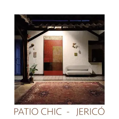 a living room with a red door and a rug at Patio Chic House in Jericó