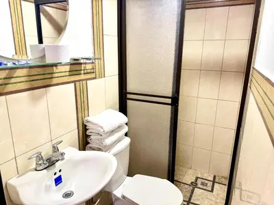 a bathroom with a white toilet and a sink at Hotel Estadio 80 in Medellín