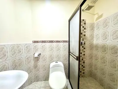 a bathroom with a toilet and a sink at Hotel Estadio 80 in Medellín
