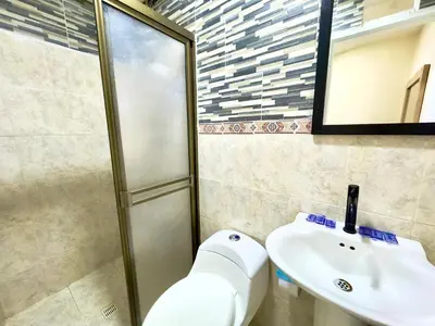 a bathroom with a toilet and a sink at Hotel Estadio 80 in Medellín