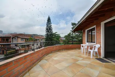 a patio with a table and chairs on a balcony at Vista Magnolia in Envigado