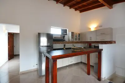 a kitchen with a wooden table and a refrigerator at Vista Magnolia in Envigado