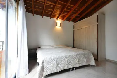 a bedroom with a bed with a wooden ceiling at Vista Magnolia in Envigado