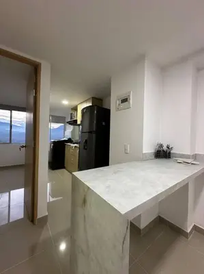 a kitchen with a white counter top in a room at Medellín central in Medellín