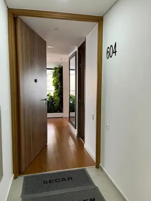 an empty hallway with a door and a sign on the wall at Apartamento Montreal in Medellín