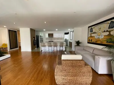 a living room with a couch and a table at Apartamento Montreal in Medellín