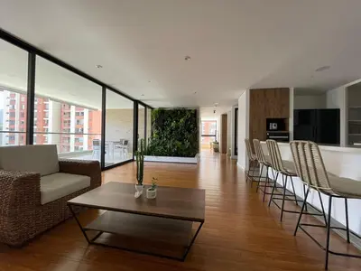 a living room with a couch and a table at Apartamento Montreal in Medellín