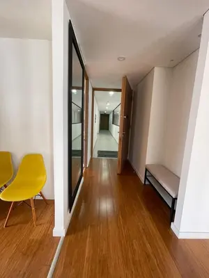 a hallway of a house with a yellow chair at Apartamento Montreal in Medellín