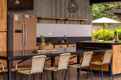 a kitchen with a black table and chairs at Monteclaro Campestre - En Sopetran in Sopetran