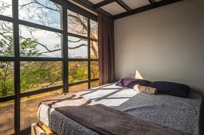 a bedroom with a bed and a large window at Monteclaro Campestre - En Sopetran in Sopetran