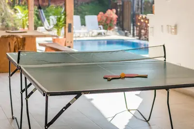a ping pong table with a tennis ball on it at Monteclaro Campestre - En Sopetran in Sopetran