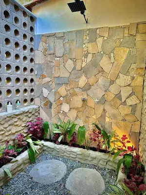 a stone wall with some plants and flowers at Monteclaro Campestre - En Sopetran in Sopetran