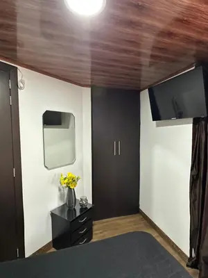a bedroom with a bed and a tv on the wall at Habitación privada in Manizales