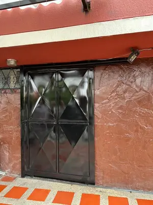 a metal door on the side of a building at Habitación privada in Manizales