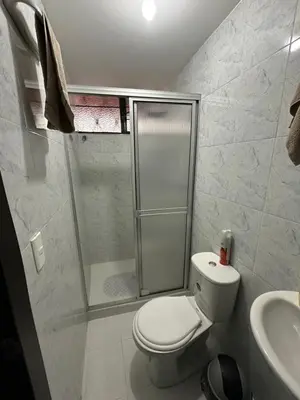 a bathroom with a shower and a toilet and a sink at Habitación privada in Manizales