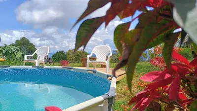 two chairs and a swimming pool in a yard at Camping San Gabriel in Angostura